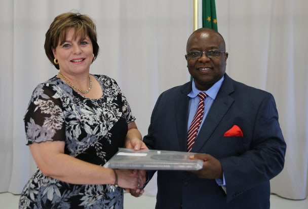 LSN CEO handing over LSN Commemorative Book to Judge President